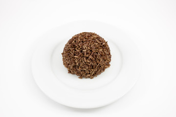 The cooked dark brown rice on the white plate for good healthy.