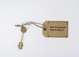 Key and a note on a white background with text -The Weekend Star
