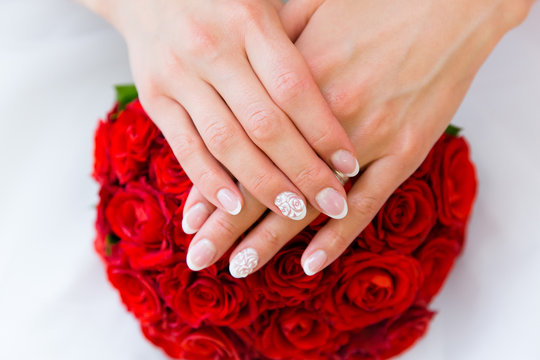 Hands of the bride on a beautiful wedding bouquet