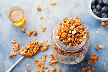 Healthy breakfast Fresh granola, muesli with berries in a glass jar on a stone background Copy space