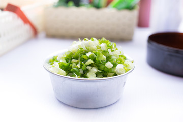 Scallion or onion tree shredded on aluminum silve cup.