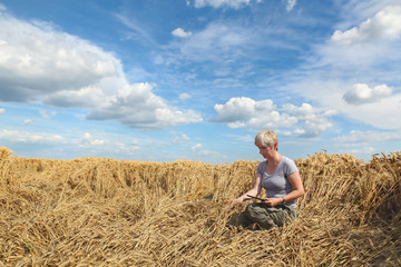 Naklejka na ściany i meble Farmer or agronomist inspect damaged wheat field