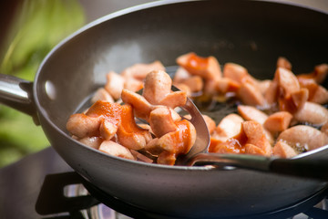Shredded sausage deep frying in hot oil.