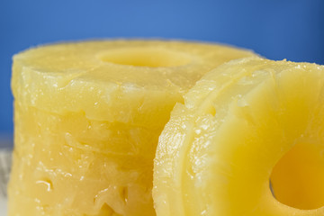 Close-up of canned pineapple slices, preserved at its own juice