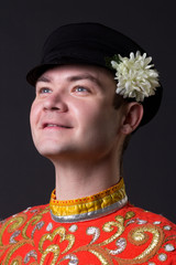 Portrait of a young guy wearing a folk russian costume