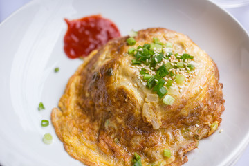 fried egg omelette with scallion and white sesame ready to serve on dish.