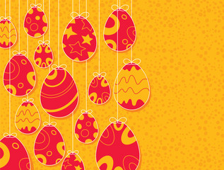 Easter eggs hanging with orange background
