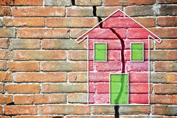 Cracked brick wall with a colored house drawn on it - obrazy, fototapety, plakaty