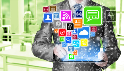 Business man using tablet PC with social media icon set