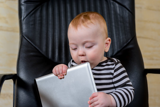 Adorable Baby Boy Holding Tablet Computer