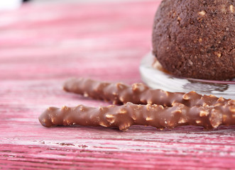Cupcake with chocolate on wooden background