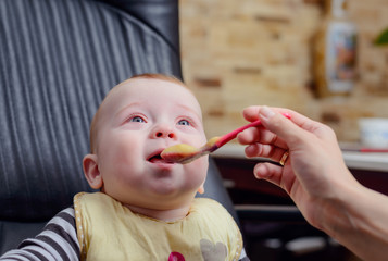 Happy Baby on Chair Eating Porridge Food