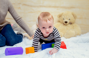 Pretty Mom with her Cute Baby Playing at Home