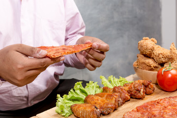 Man is holding his burger ready to eat