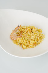 Paella, typical Spanish dish on white background.