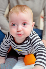 Fototapeta premium Cute chubby young baby with a pensive look