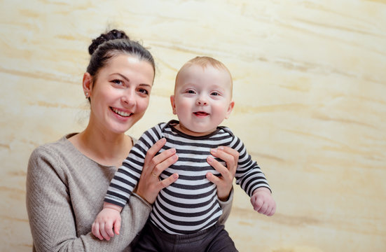 Young mother holding her happy healthy baby