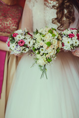 Beatiful bride with boquet in the hend