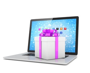 Gift box with ribbon on laptop keyboard