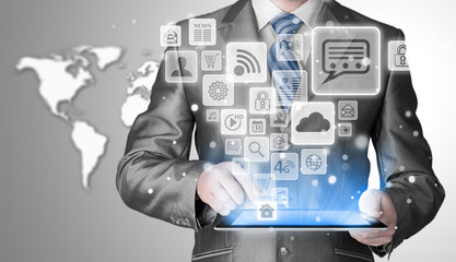 Business man using tablet PC with social media icon set