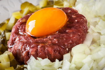Steak tartare with egg yolk, onions and pickles
