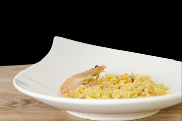 Paella, typical Spanish dish on white background.