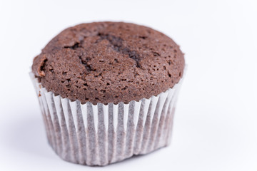 Macro view of chocolate muffin over white