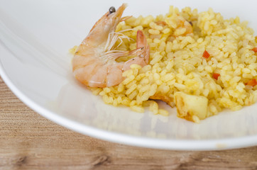 Paella, typical Spanish dish on white background.