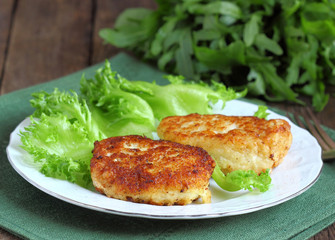 Cod fish cakes served with a salad.
