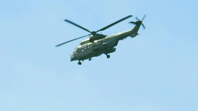 Military Army helicopter flying in air against sky