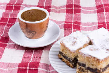 Cup of coffee with cakes on the plate