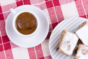 Cup of coffee with cakes on the plate