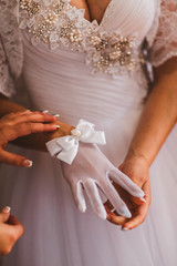 The bride wears white gloves