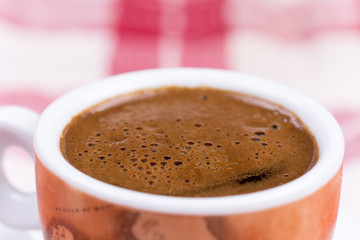 Close macro view of cup of coffee ballons