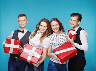 Smiling hipster group with the gifts in the studio