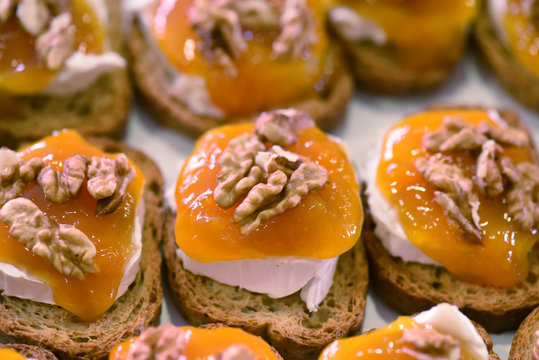Soft Cheese and apricot pintxo topped with walnuts
