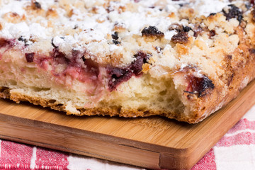 Grandmothers cake with cherries on the wooden board