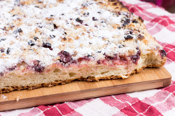 Grandmothers cake with cherries on the wooden board