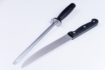Kitchen knife and shrapening tool over white background