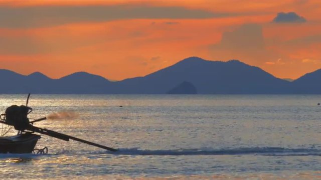 Fishing boat silhouette at sunset near Krabi and Phuket island in south Thailand