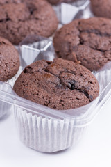 Bunch of brown chocolate muffins over white background