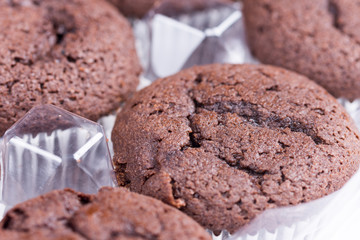 Bunch of brown chocolate muffins over white background
