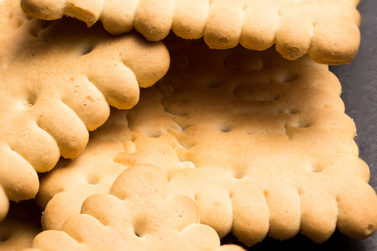 Several biscuits on black tabletop. High resolution image.
