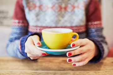 Woman hands with red manicure and cup of coffee