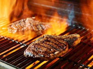 Fotobehang ribeye steak barbecue op de grill © Joshua Resnick
