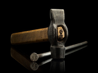 Old hammer and the big rusty nail