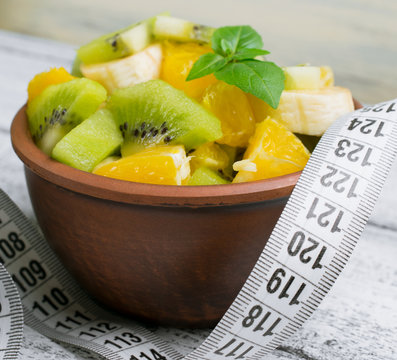 Fruit salad with kiwi, banana and orange for slimming and centim