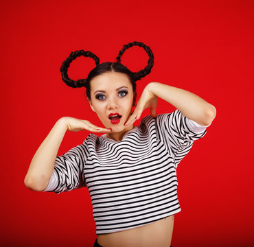 High fashion girl with unusual hairstyle like Minnie Mouse in the studio