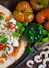 A hand stretched,wood fired pizza base topped with tomato and fresh basil,mozzarella cheese ,garlic king prawns,red chilli and coriander.