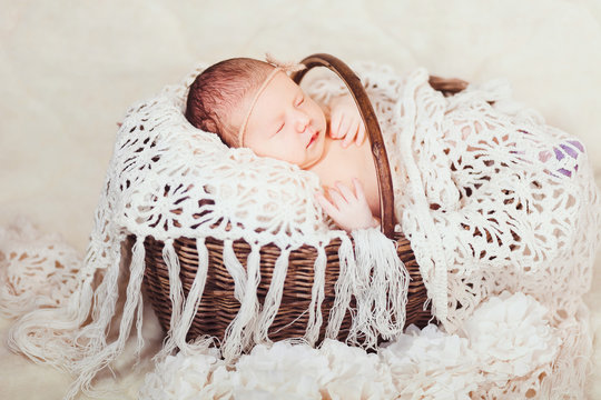 A Baby Who Sleeps In A Basket